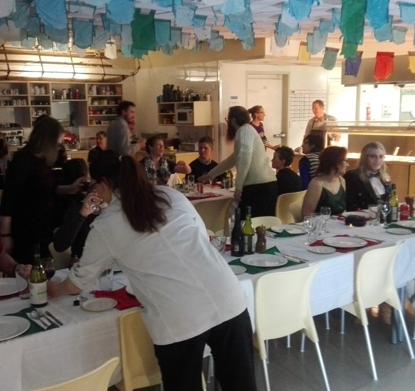 Researchers gathered at a long dining table for the Midwinter dinner at Scott Base, Antarctica